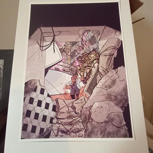 May include: A framed comic book art print depicting a scene of destruction. The artwork features a figure in a white shirt and gray pants amidst rubble. The color palette includes shades of gray, pink, and black, with a white mat.