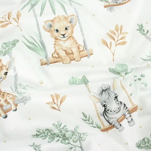 May include: White fabric with a repeating pattern of jungle animals on swings. The animals include a giraffe, a lion, a zebra, and a leopard. The animals are all in a cartoon style and are surrounded by green leaves.