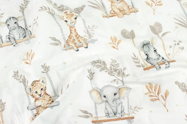May include: A white fabric with a repeating pattern of various animals on swings. The animals include a giraffe, zebra, lion, and elephant. The animals are all depicted in a watercolor style and are surrounded by leaves and branches.