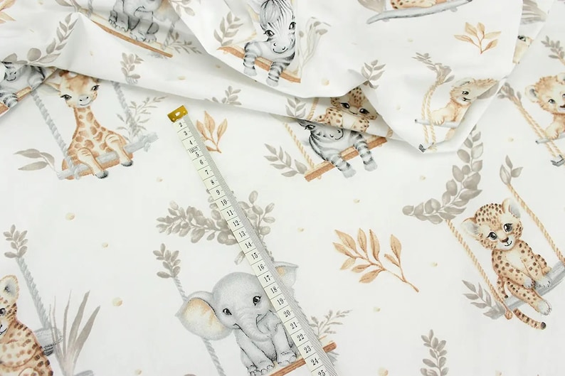 May include: White fabric with a repeating pattern of various animals on swings. The animals include a giraffe, zebra, elephant, and leopard. The fabric has a watercolor-like design with brown, gray, and beige colors.