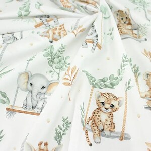 May include: White fabric with a repeating pattern of jungle animals on swings. The animals include a lion, a leopard, an elephant, and a zebra. The animals are drawn in a watercolor style with muted colors.