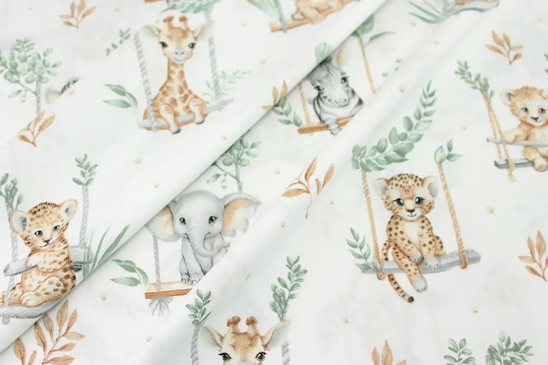 May include: White fabric with a repeating pattern of jungle animals on swings. The animals include a giraffe, elephant, leopard, and zebra. The fabric has a watercolor-like style with green leaves and brown branches.