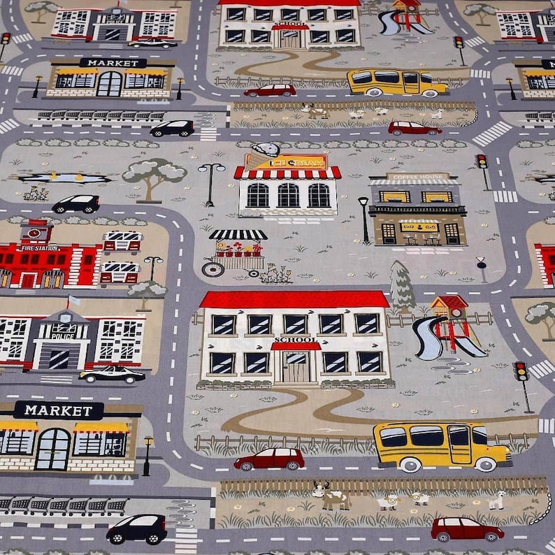 May include: A colorful play mat with a city theme. The mat features a school, a market, a coffee house, a fire station, and a police station. There are also cars, trucks, and people on the mat.