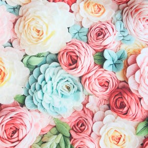 May include: A white ceramic mug with a black handle and the text "But First, Coffee" in a black, handwritten-style font. The mug is on a white surface.