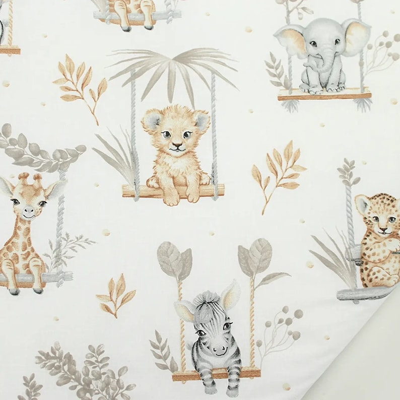 May include: White fabric with a repeating pattern of jungle animals on swings. The animals include a giraffe, lion, zebra, elephant, and leopard. The animals are all in a cartoon style and are surrounded by leaves and vines.