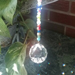 Crystal ball prism and the cutest glass ladybug, with bright multicolor crackle and millefiori glass beads make an exceptional suncatcher.