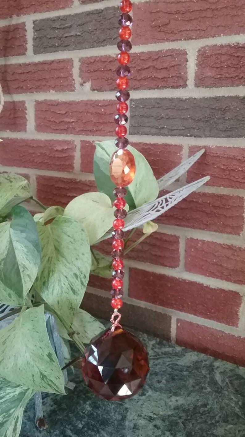 Orange /& maroon burgundy suncatcher with orange ball prism maroon and orange glass beads and a perfect center faceted orange glass gem!