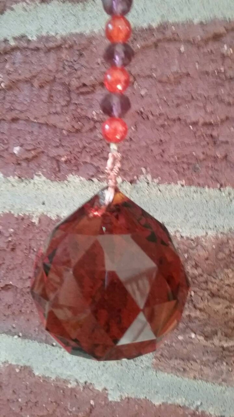 Orange /& maroon burgundy suncatcher with orange ball prism maroon and orange glass beads and a perfect center faceted orange glass gem!