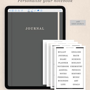 May include: A digital tablet with a grey screen displaying the word "JOURNAL" in white text. The tablet is on a white background. A stack of printable label stickers with various categories, such as "Bullet Journal", "English", "Maths", "Diary", "Science", "Planner", "Biology", "Notebook", "Chemistry", "Agenda", "Physics", "Notes", "History", "Personal", "Music", "Business", "Art", "Life", and "Goals" are shown to the right of the tablet.