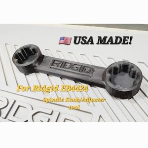May include: A black plastic wrench tool for a Ridgid EB4424 spindle knob/adjuster. The wrench is labeled "RIDGID" and "USA MADE!"