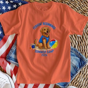 May include: Orange t-shirt featuring a golden retriever wearing a blue vest with the name "Hello" on it. The shirt has the text "FERVENT BEGINNINGS SUMMER CAMP 2026" and a beach ball graphic.