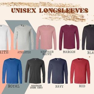 May include: A selection of unisex long-sleeved shirts in various colours, including white, athletic grey, heather mauve, maroon, black, royal blue, heather dark grey, navy, and red. The shirts are all long-sleeved and have a crew neck.