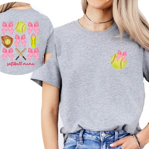 May include: Gray t-shirt with a softball and pink bows on the front and the text "softball mama" on the back.