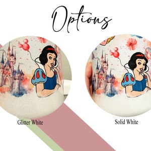 May include: Two white mugs with a watercolor design of Snow White and the castle from Disney's Snow White and the Seven Dwarfs. The mug on the left is glitter white and the mug on the right is solid white.