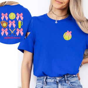 May include: A royal blue t-shirt with a softball and pink bows on the front. The back of the shirt has a softball, pink bows, crossed bats, and the text "softball mama".