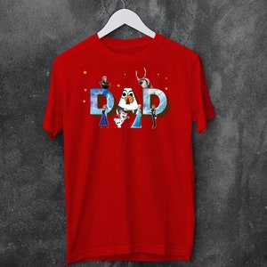 May include: Red t-shirt featuring a graphic of the characters from the film Frozen spelling out the word "DAD" with stars in the background.