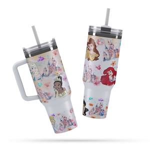 May include: Two stainless steel tumblers with lids and straws. The tumblers are white with a colorful design featuring Disney princesses, castles, and balloons.