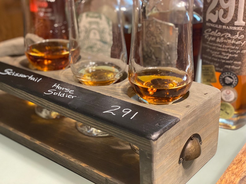 Handmade flight crate in classic gray shown being used with tasting glasses and whiskey tasting. Chalkboard design allows for easy drink labeling.