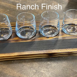 May include: Wooden serving tray with a black stain and four clear glass cups. The tray has a "Ranch Finish" label.