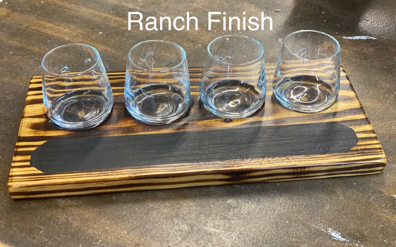 May include: Wooden serving tray with a black stain and four clear glass cups. The tray has a "Ranch Finish" label.
