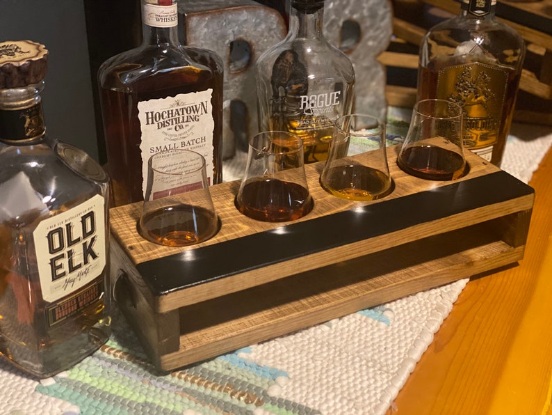 Handmade flight crate for tasting parties in special walnut finish. Crate design allows for secure drink placement and built in chalkboard design provides easy labeling for drinks. Shown with whiskey and Glencairn glasses.