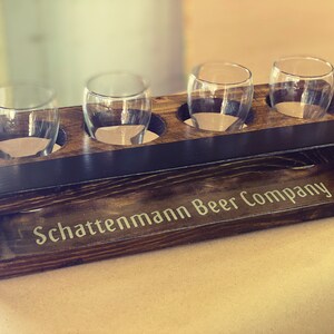 Handmade flight crate with finger pull handles and chalkboard shown with personalization and beer tasting glasses.