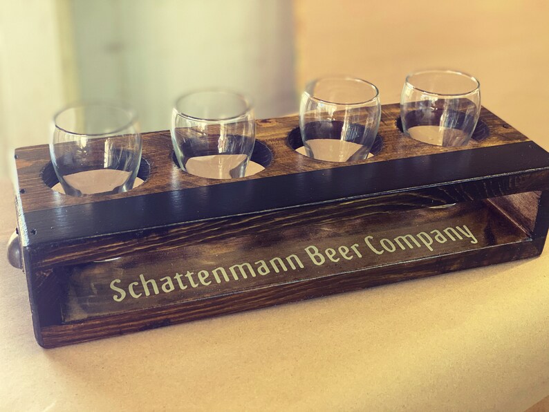Handmade flight crate with finger pull handles and chalkboard shown with personalization and beer tasting glasses.
