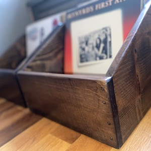 Two handcrafted vinyl record storage crates in dark walnut finish sitting on the floor.