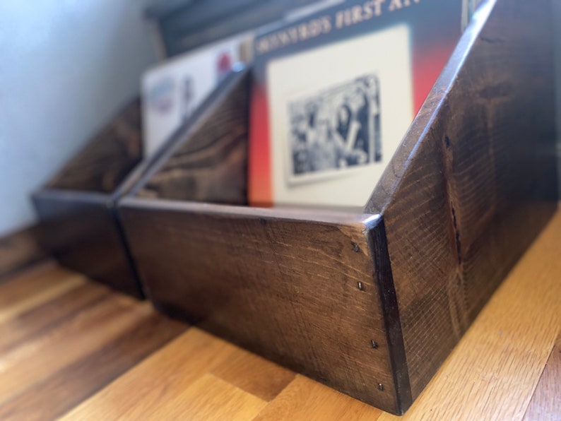 Two handcrafted vinyl record storage crates in dark walnut finish sitting on the floor.