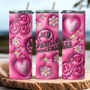 May include: Three pink stainless steel tumblers with different designs. The first tumbler has a pink background with a dripping smiley face, a flower, and a heart. The second tumbler has a pink background with a dripping smiley face, a flower, and the text "Professional Overthinker". The third tumbler has a pink background with a dripping smiley face, a flower, and a heart.