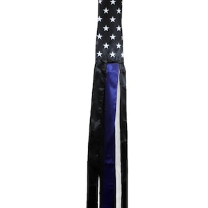 May include: A black and white American flag windsock with blue, black, and white streamers.