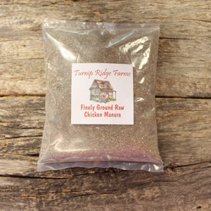 May include: A clear plastic bag filled with finely ground raw chicken manure. The bag has a label that reads "Turnip Ridge Farms" and "Finely Ground Raw Chicken Manure".