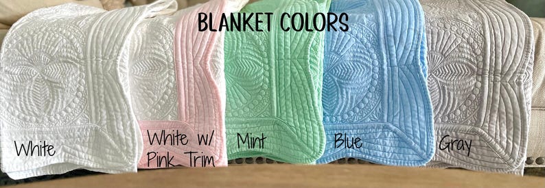 May include: Five quilted baby blankets in different colors: white, white with pink trim, mint, blue, and gray. The blankets are arranged horizontally with the text "BLANKET COLORS" above them.
