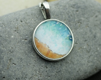 Necklace with the sound of the sea from a self-painted watercolor picture under a cabochon in the color silver