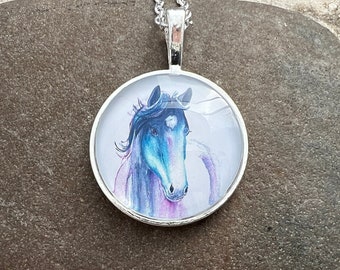 May include: A silver necklace with a round pendant featuring a watercolor painting of a blue and purple horse's head.