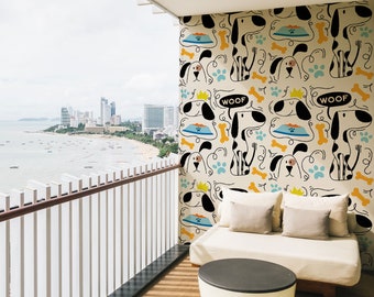 May include: A white couch with two pillows sits on a balcony with a wooden floor. The wall behind the couch is covered in a wallpaper with a pattern of black and white dogs, bones, and paw prints. The wallpaper also has the word "WOOF" written on it. The balcony has a white railing and a view of a city skyline and the ocean.