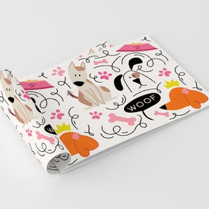 May include: White wrapping paper with a repeating pattern of dogs, bones, paw prints, and the word "WOOF". The dogs are brown, black, and orange.