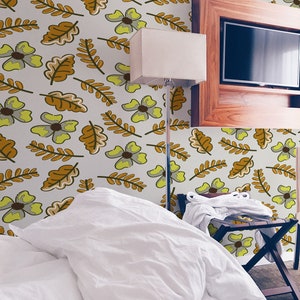 May include: A white bed with a white duvet and a white pillow. The bed is in a room with a light brown wall with a floral pattern. There is a wooden TV stand with a flat screen TV on top of it. A lamp is on the left side of the bed.