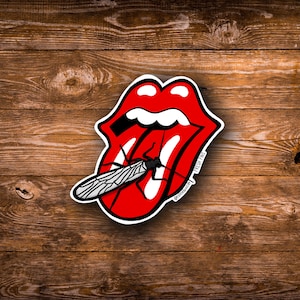 May include: A red and white tongue graphic with a black insect biting into it. The graphic has the text "FRESH FINDS" and "@fishbouz.art" on it.