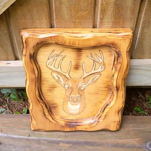 Hand-carved wooden deer wall hanging