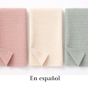 May include: Three rectangular blankets featuring a consistent crochet stitch pattern. The blankets are arranged side-by-side in soft pastel colors: a dusty rose pink on the left, a creamy off-white in the center, and a muted sage green on the right.