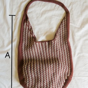 May include: A handmade crochet shoulder bag in a vertical striped pattern of burgundy and cream. The bag has a rounded bottom and a single strap. The bag's dimensions are approximately 15 inches wide and 20 inches long.
