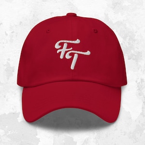 May include: A red baseball cap with a white embroidered design that says "FT".