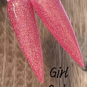 May include: Two pink nail polish bottles with glitter, one is partially visible and the other is fully visible. The text "Girl Code" is written below the bottles.