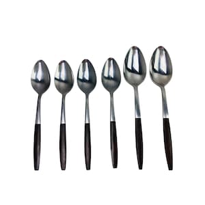 May include: Six stainless steel spoons with a reflective surface and dark brown handles are arranged on a white background. The spoons are of varying sizes, suggesting a set for dining or serving.