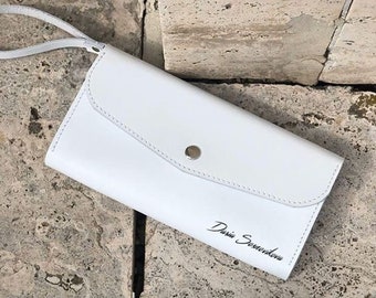 white leather wristlet
