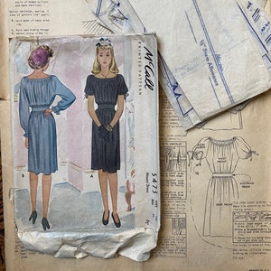 May include: Vintage McCall's sewing pattern for a dress, size 16, with instructions and illustrations. The pattern number is 5473.