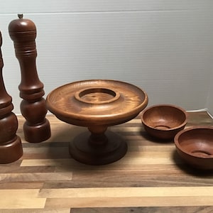 Assortment of Midcentury Teak Serving Pieces Including Salt and Pepper Shakers, a Food Stand or Cheese Board and Two Bowls