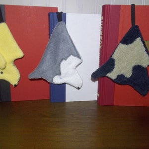 Variety of Smudge Dogs shown being used as bookmarks.