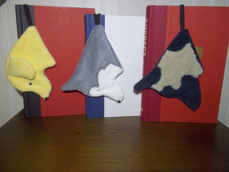 Variety of Smudge Dogs shown being used as bookmarks.